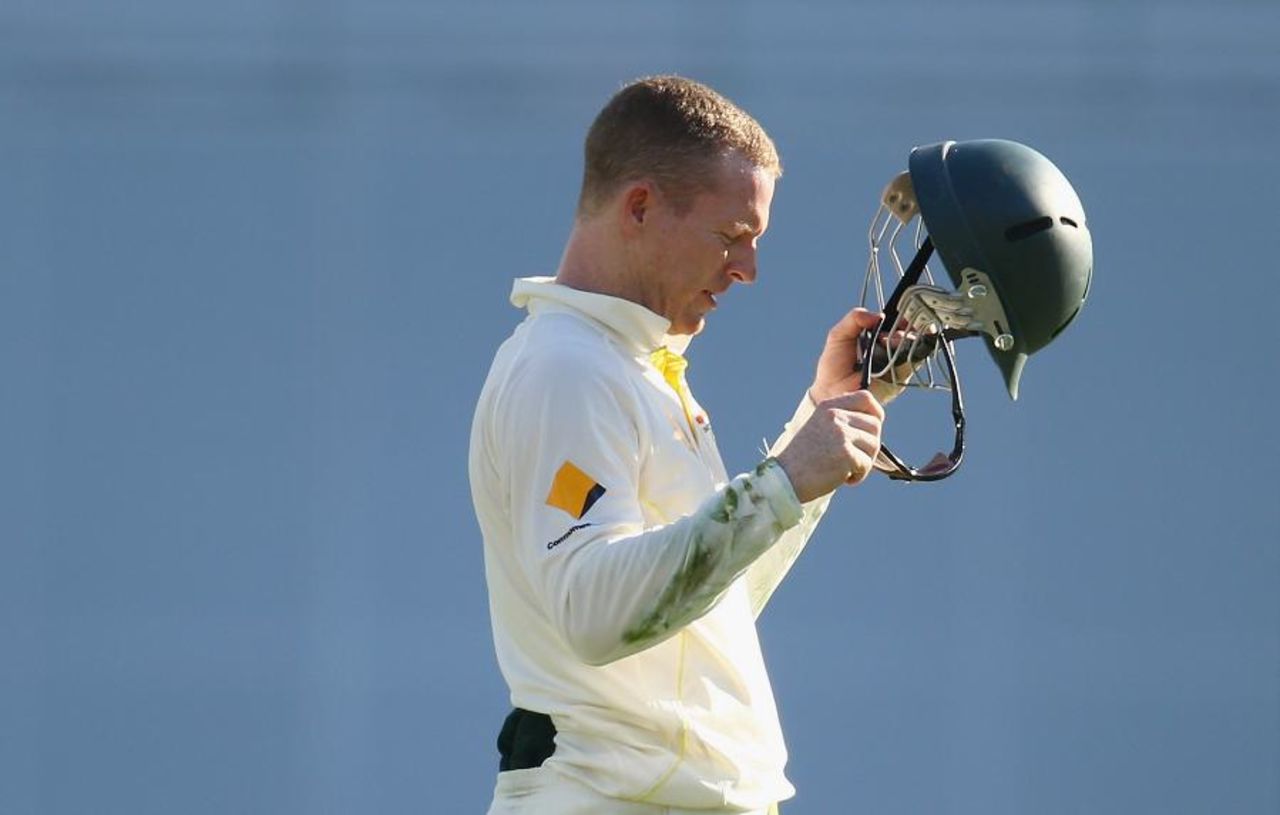 Chris Rogers checks his helmet after being hit in the field, Australia v India, 2nd Test, Brisbane, 1st day, December 17, 2014
