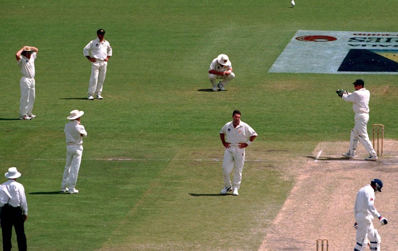 Shane Warne on his haunches after dropping a catch that could have given Damien Fleming a hat-trick, Australia v India, 1st Test, Adelaide, 5th day, December 14, 1999  