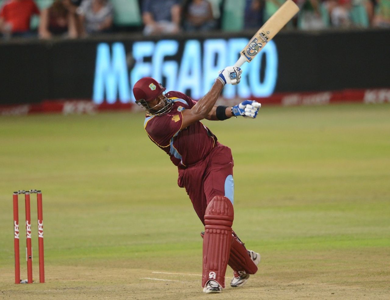 Kieron Pollard takes one hand off the bat as he hits, South Africa v West Indies, 3rd T20, Durban, January 14, 2015