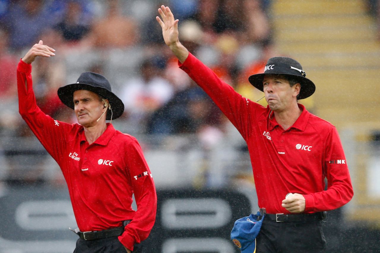 Taxi! Billy Bowden and Nigel Llong call for the covers, New Zealand v Sri Lanka, 3rd ODI, Auckland, January 17, 2015