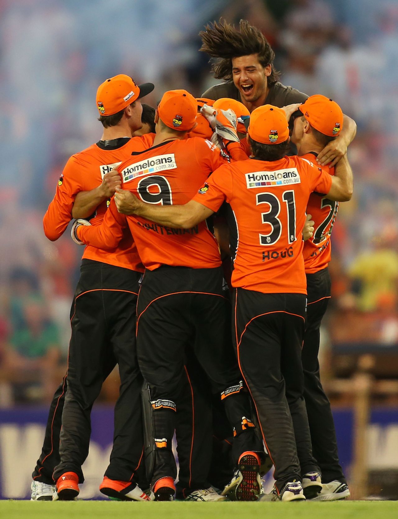 A spectator joins the Perth Scorchers players after their win, Perth Scorchers v Melbourne Stars, Big Bash League 2014-15, semi-final, Perth, January 25, 2015