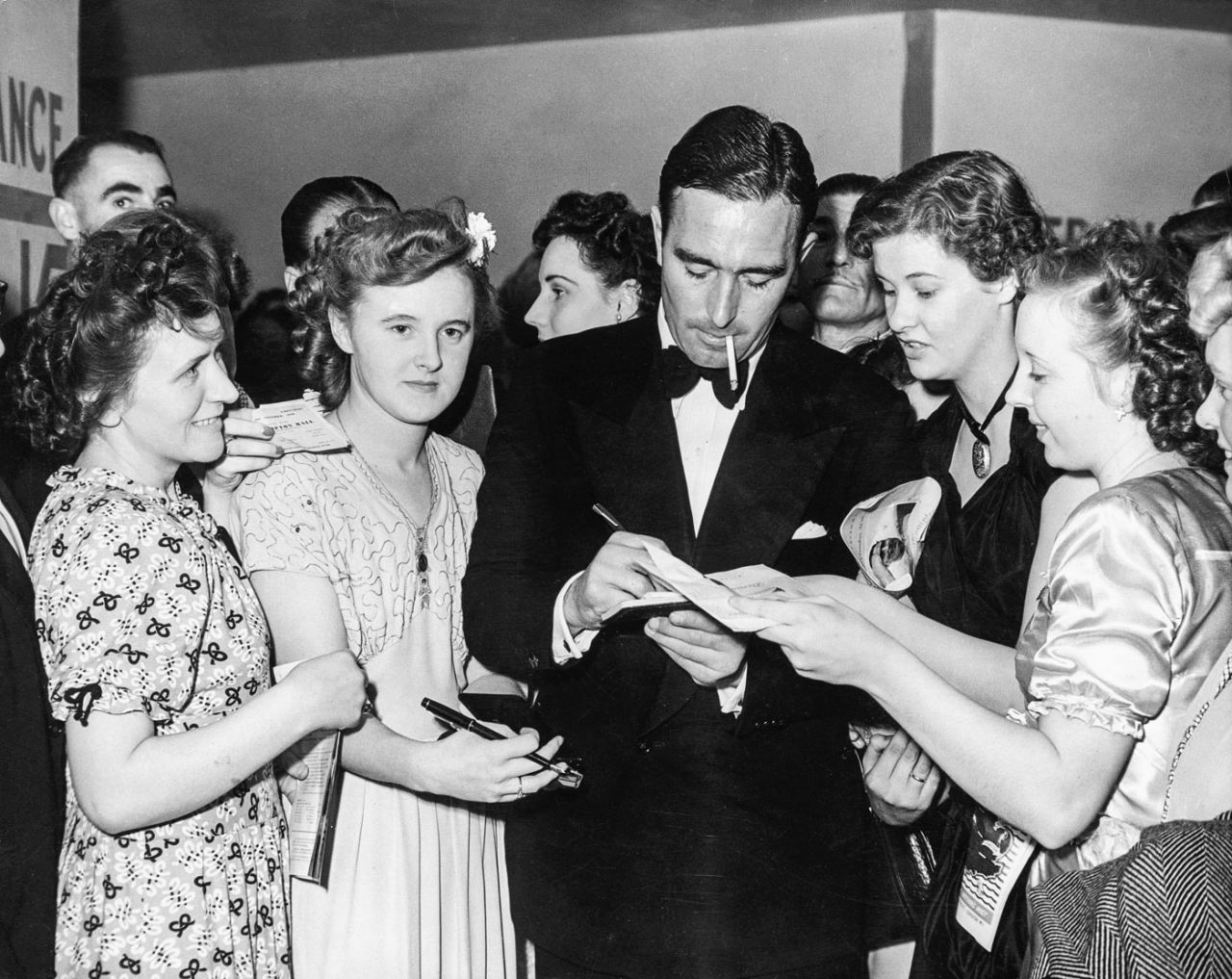 Denis Compton signs autographs for his fans at Empress Hall, London