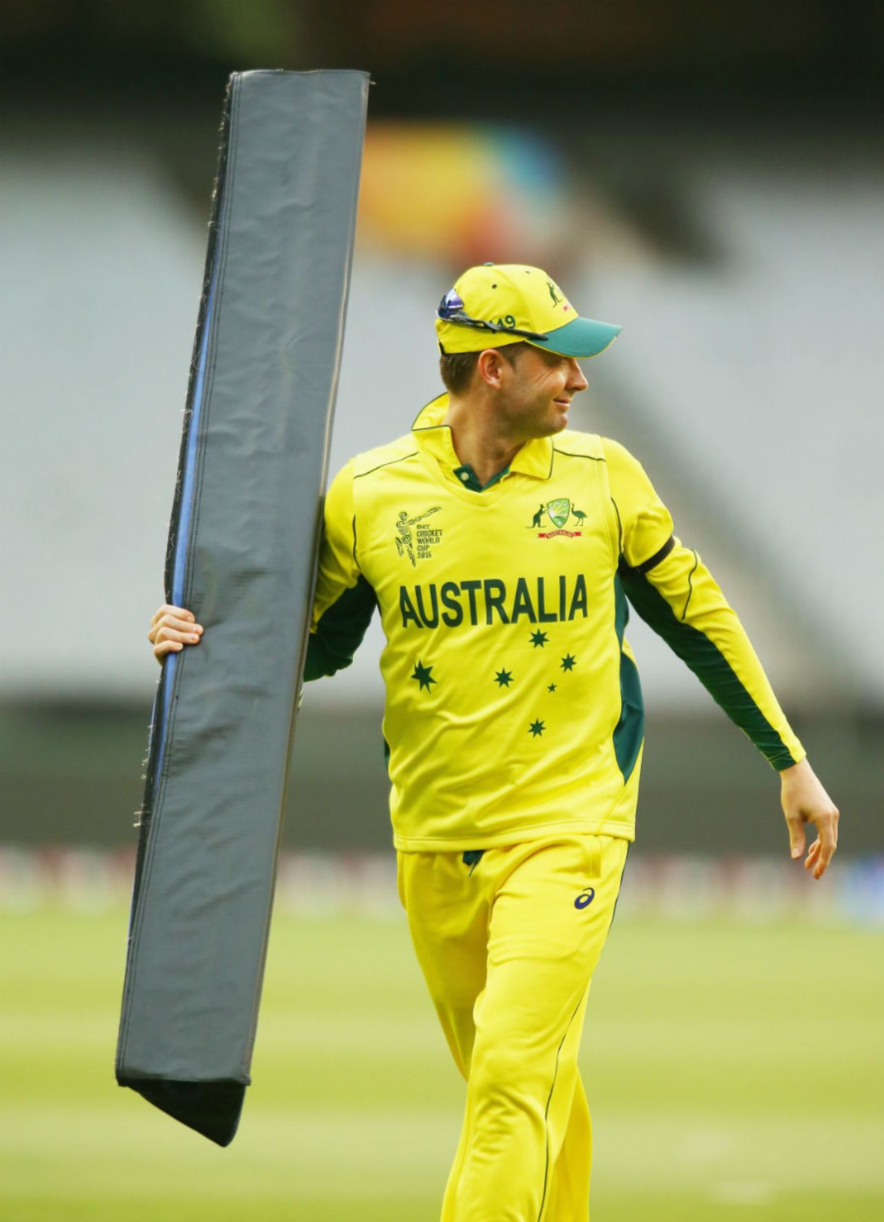 Michael Clarke picks up one of the boundary cushions that was blown onto the field, Australia v UAE, World Cup warm-up, Melbourne, February 11, 2015