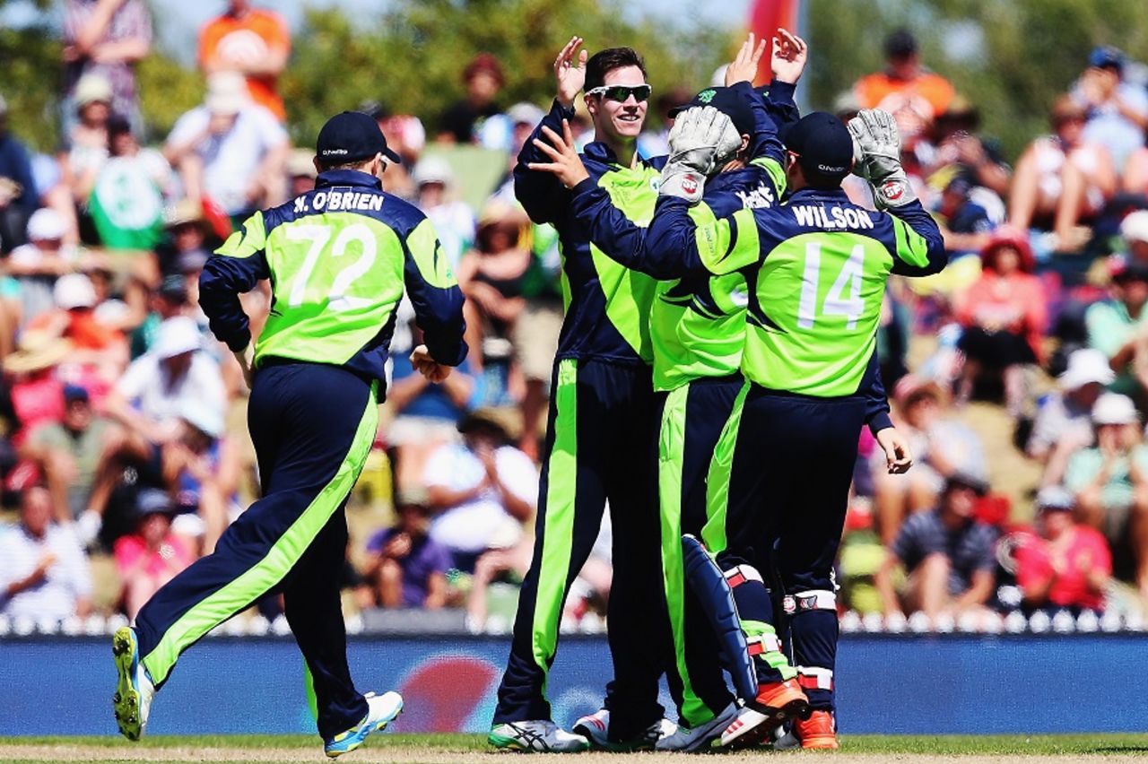 George Dockrell is mobbed by team-mates after he had Marlon Samuels lbw, Ireland v West Indies, World Cup 2015, Group B, Nelson, February 16, 2015 