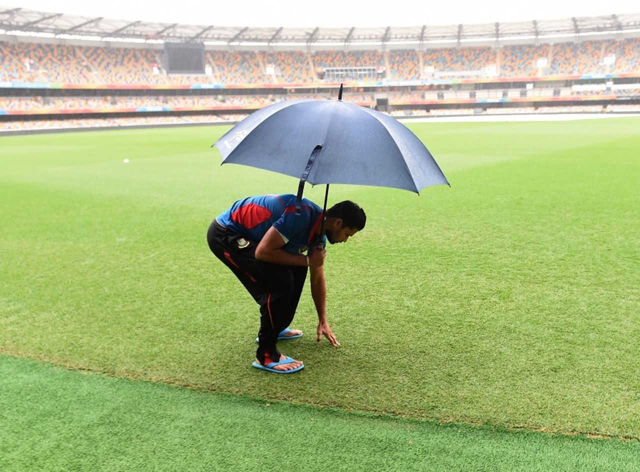 Mashrafe Mortaza inspects the wet outfield at the Gabba, World Cup, Brisbane, February 20, 2015