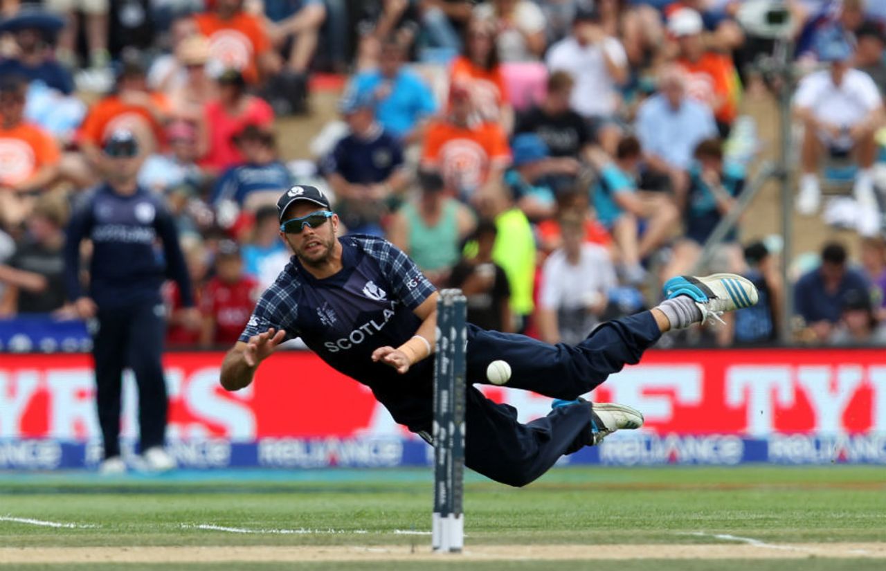 Kyle Coetzer goes airborne while attempting a direct hit, England v Scotland, World Cup 2015, Group A, Christchurch, February 23, 2015
