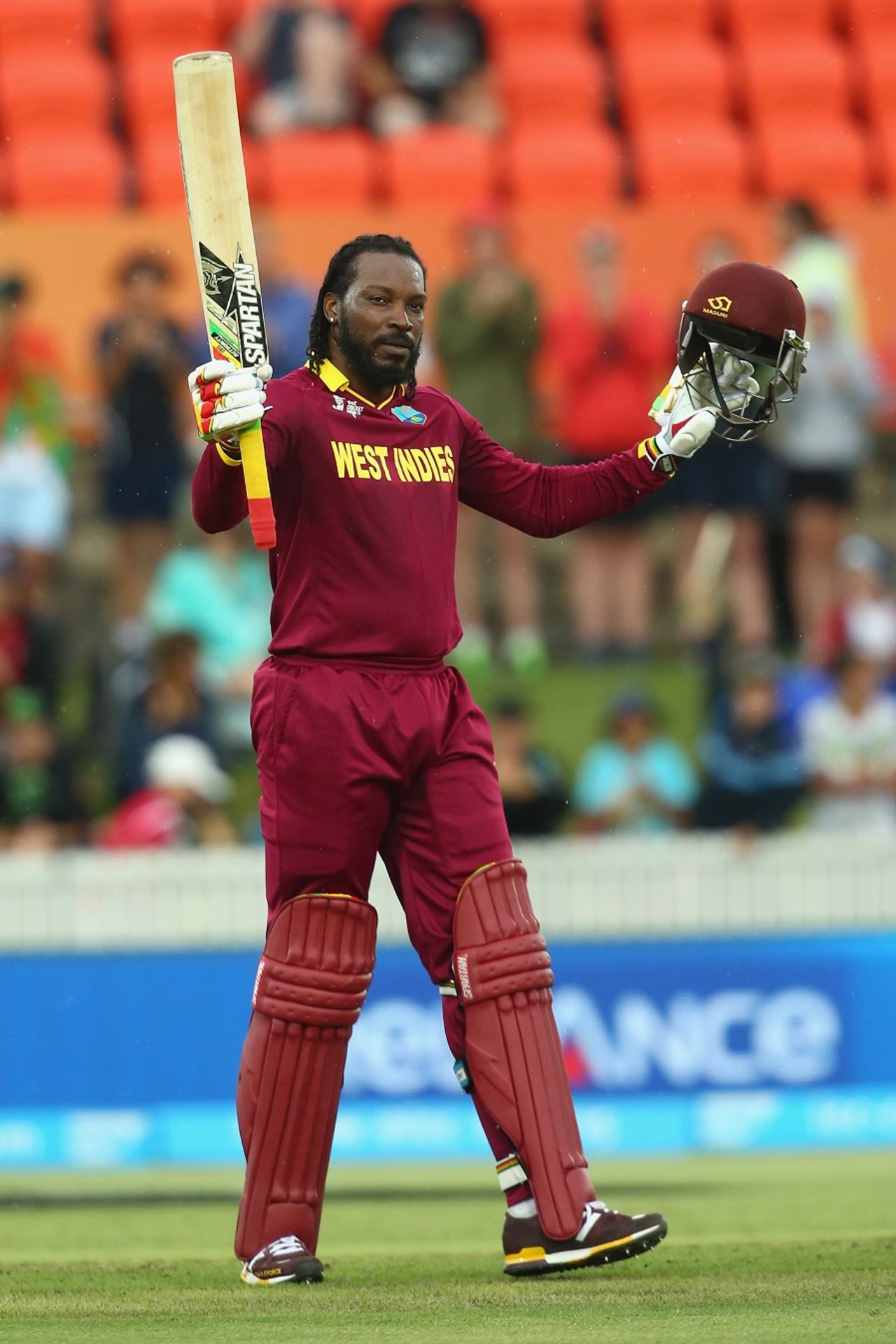 Chris Gayle raises his bat after bringing up his hundred, West Indies v Zimbabwe, World Cup 2015, Group B, Canberra, February 24, 2015