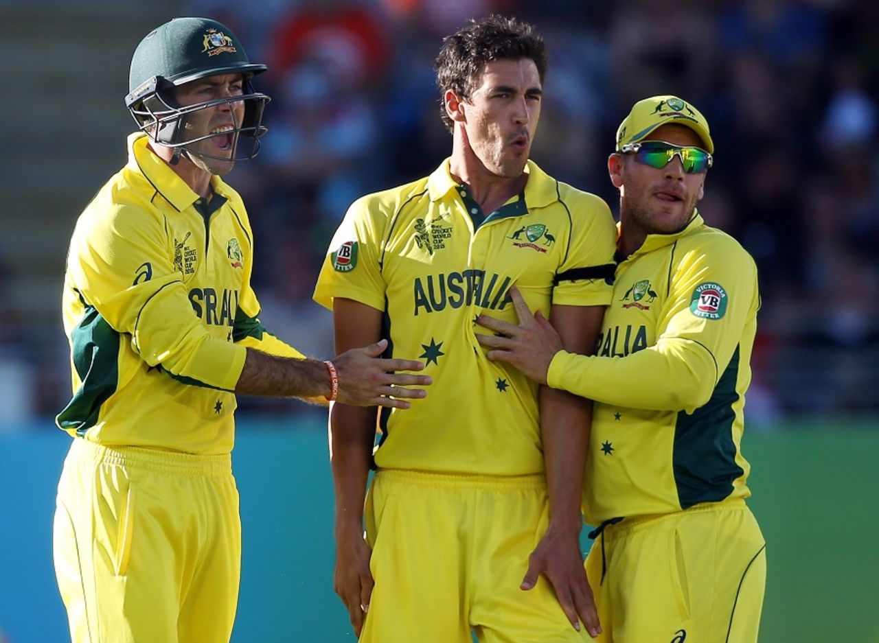 Mitchell Starc is flanked by Aaron Finch and Glenn Maxwell after striking twice in two balls, New Zealand v Australia, World Cup 2015, Group A, Auckland, February 28, 2015