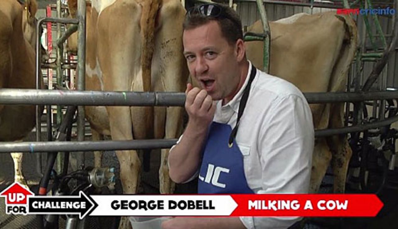 George Dobell milks a cow, New Zealand, March 2015