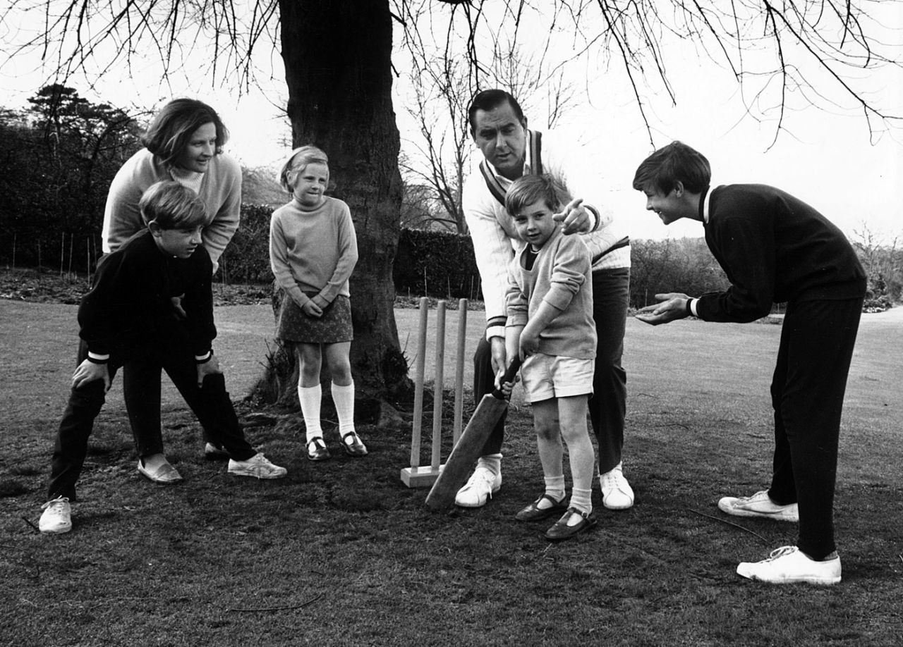 Colin Cowdrey teaches his family how to bat in the lawn of the family home in Surrey, England, April 1, 1970