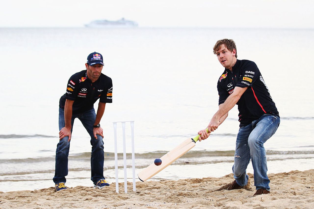 Red Bull's Sebastian Vettel tries his hand at batting at St Kilda beach, Melbourne, March 14, 2012
