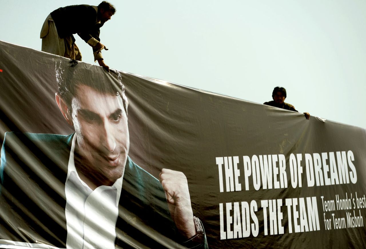 Workers put up a billboard featuring Misbah-ul-Haq, Islamabad, February 14, 2015