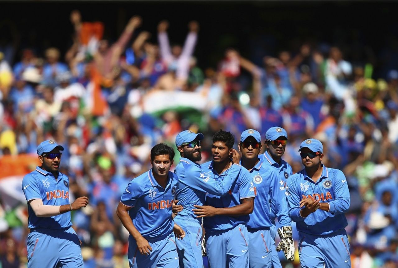 Umesh Yadav is mobbed by his team-mates after dismissing David Warner, Australia v India, World Cup 2015, 2nd semi-final, Sydney, March 26, 2015