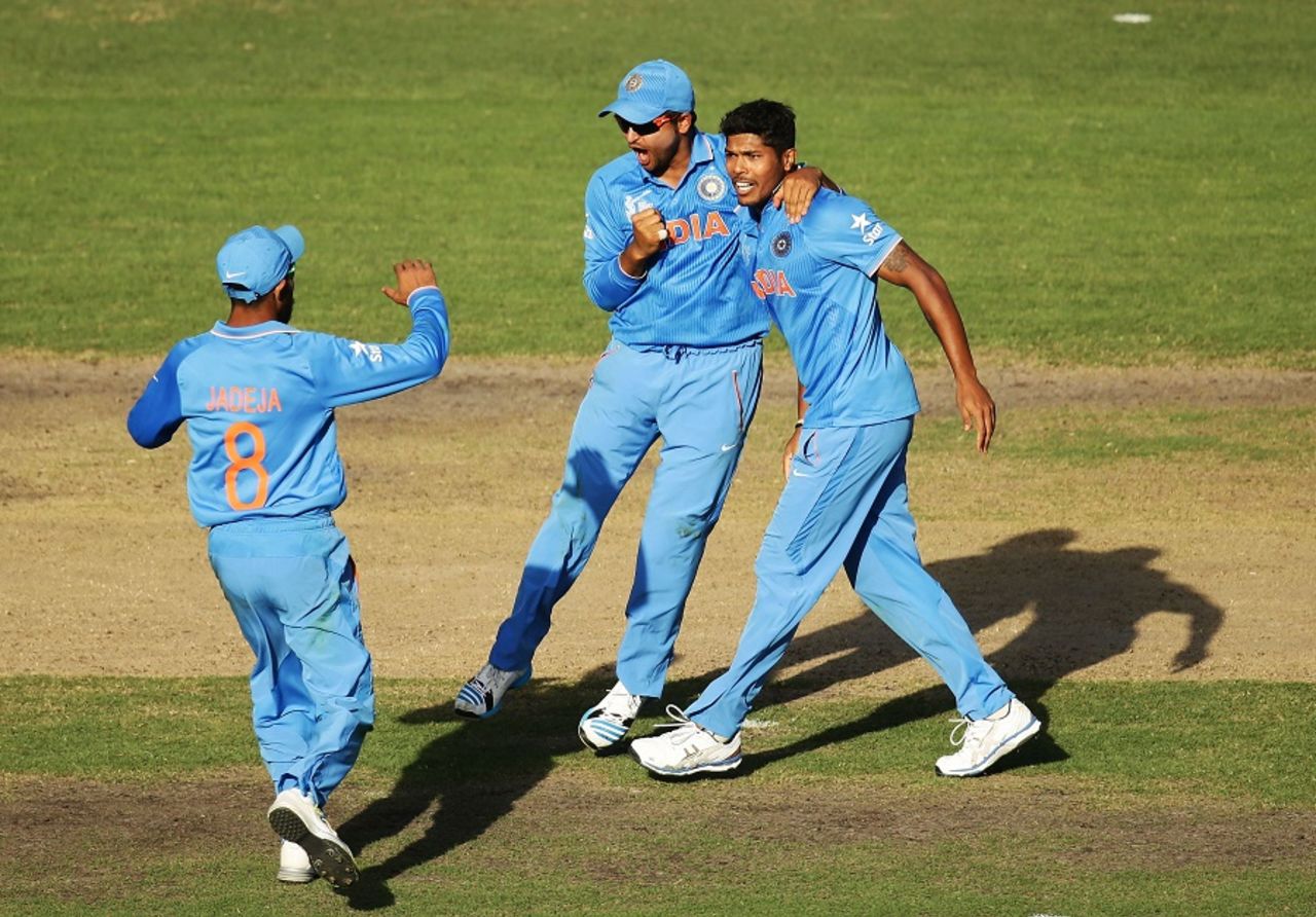Umesh Yadav and Suresh Raina celebrate the fall of Steven Smith, Australia v India, World Cup 2015, 2nd semi-final, Sydney, March 26, 2015