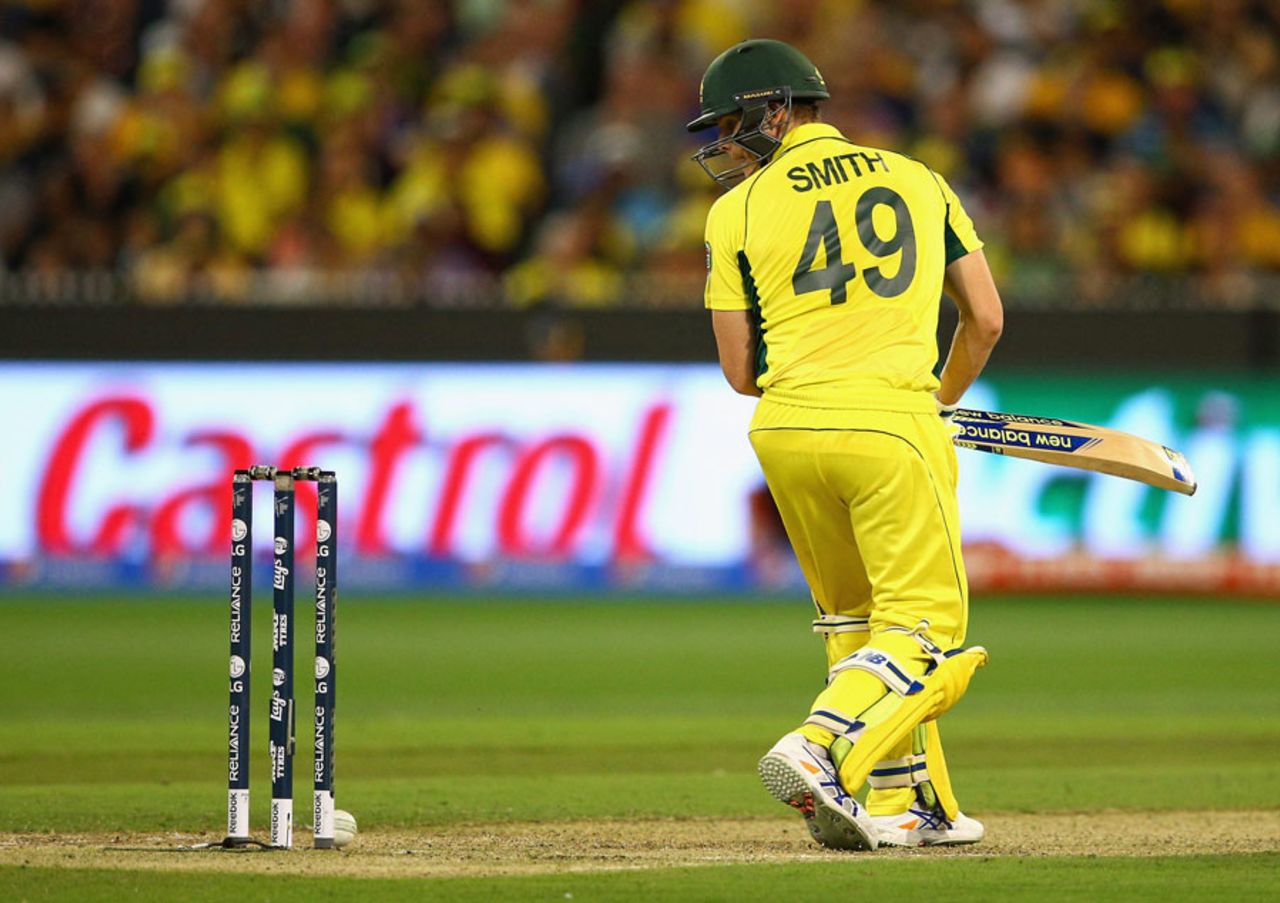 Steven Smith checks if the bails have been dislodged after the ball trickled on to the stumps, Australia v New Zealand, World Cup 2015, final, Melbourne, March 29, 2015
