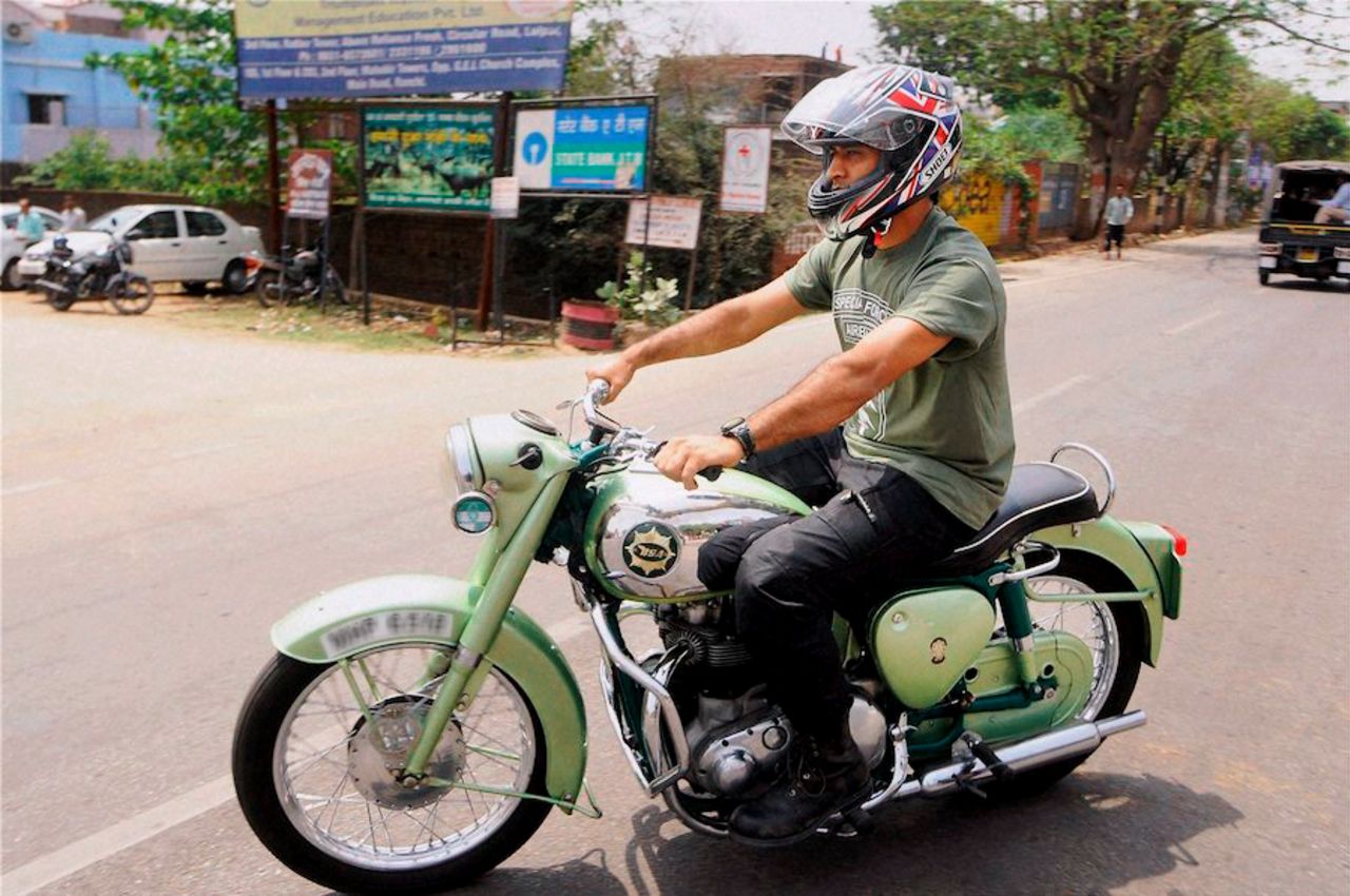 MS Dhoni rides a motorcycle in his hometown, Ranchi, April 6, 2015