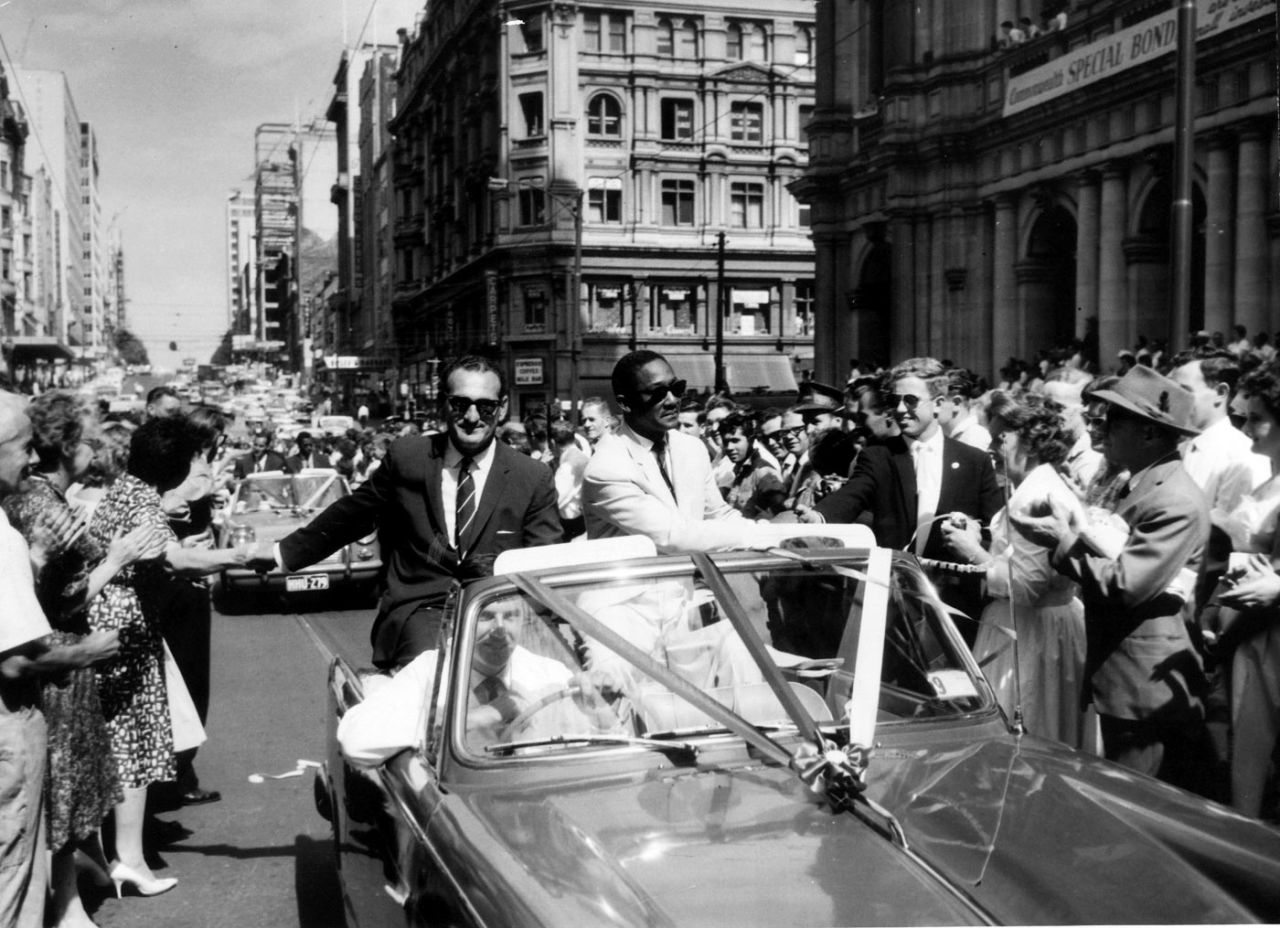 West Indies team manager Gerry Gomez and captain Frank Worrell are cheered by a huge crowd in a parade through the streets of Melbourne, February 20, 1961