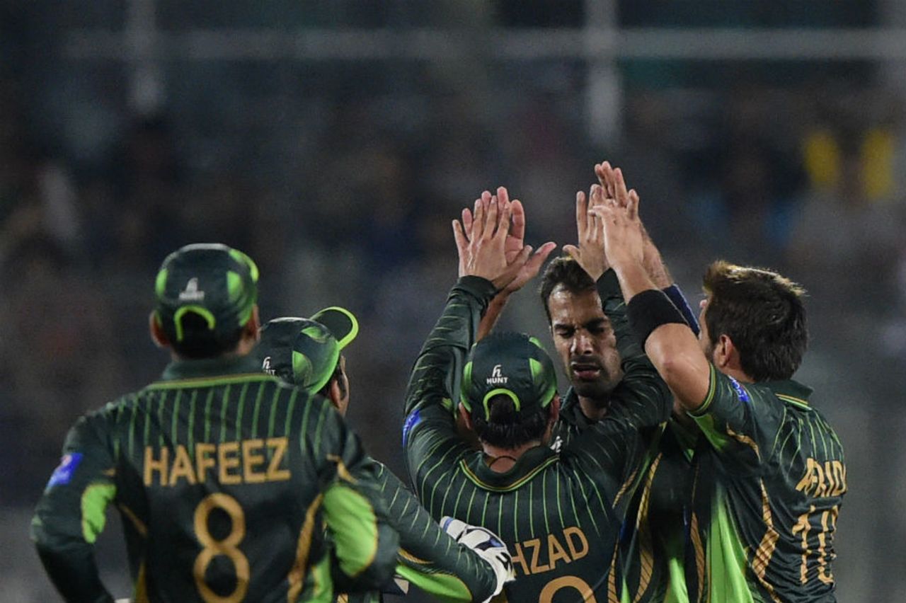 Wahab Riaz is mobbed by his team-mates after picking a wicket, Bangladesh v Pakistan, Only T20I, Dhaka, April 24, 2015 