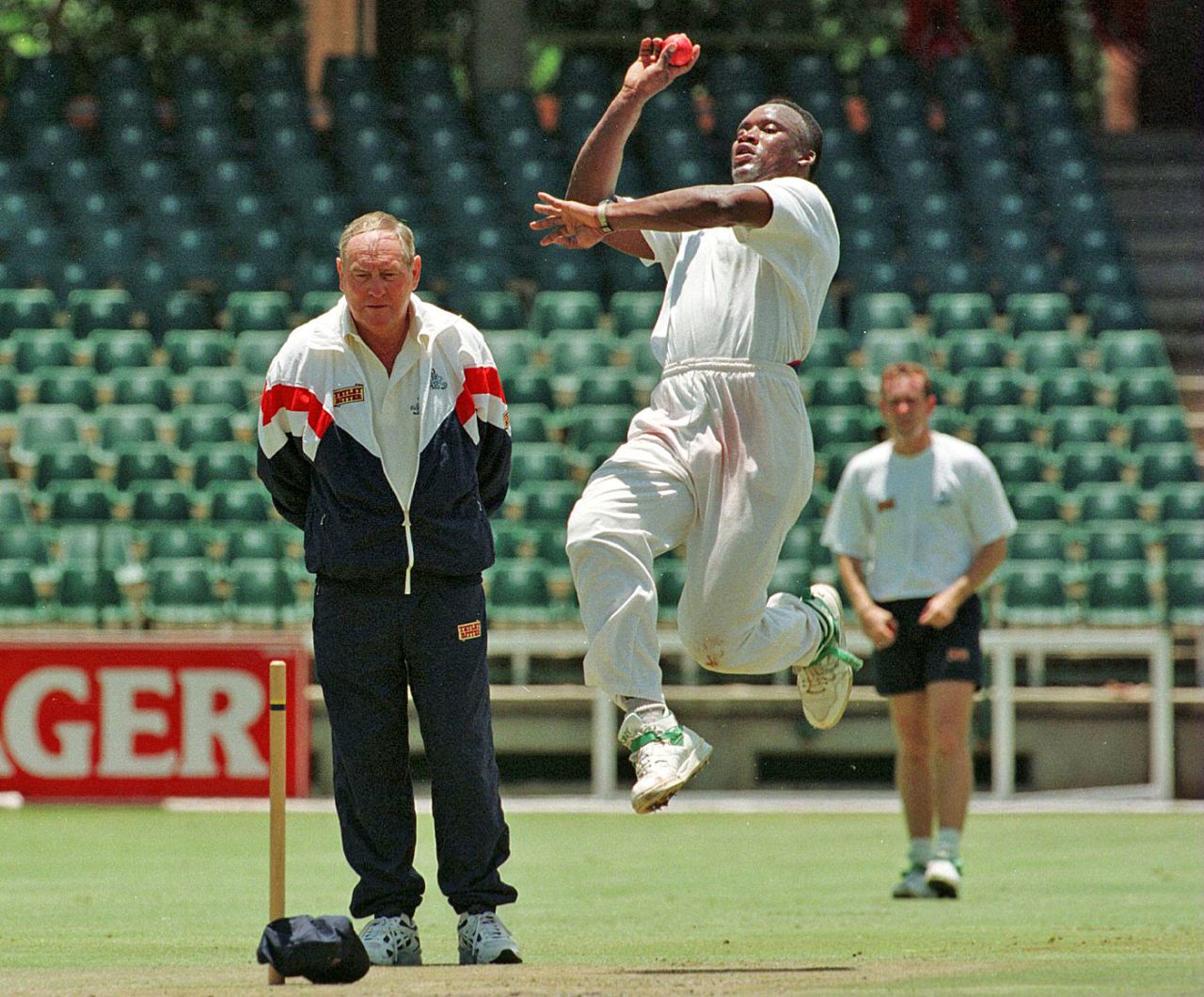 Devon Malcolm bowls as Ray Illingworth looks on, Johannesburg, November 29, 1995