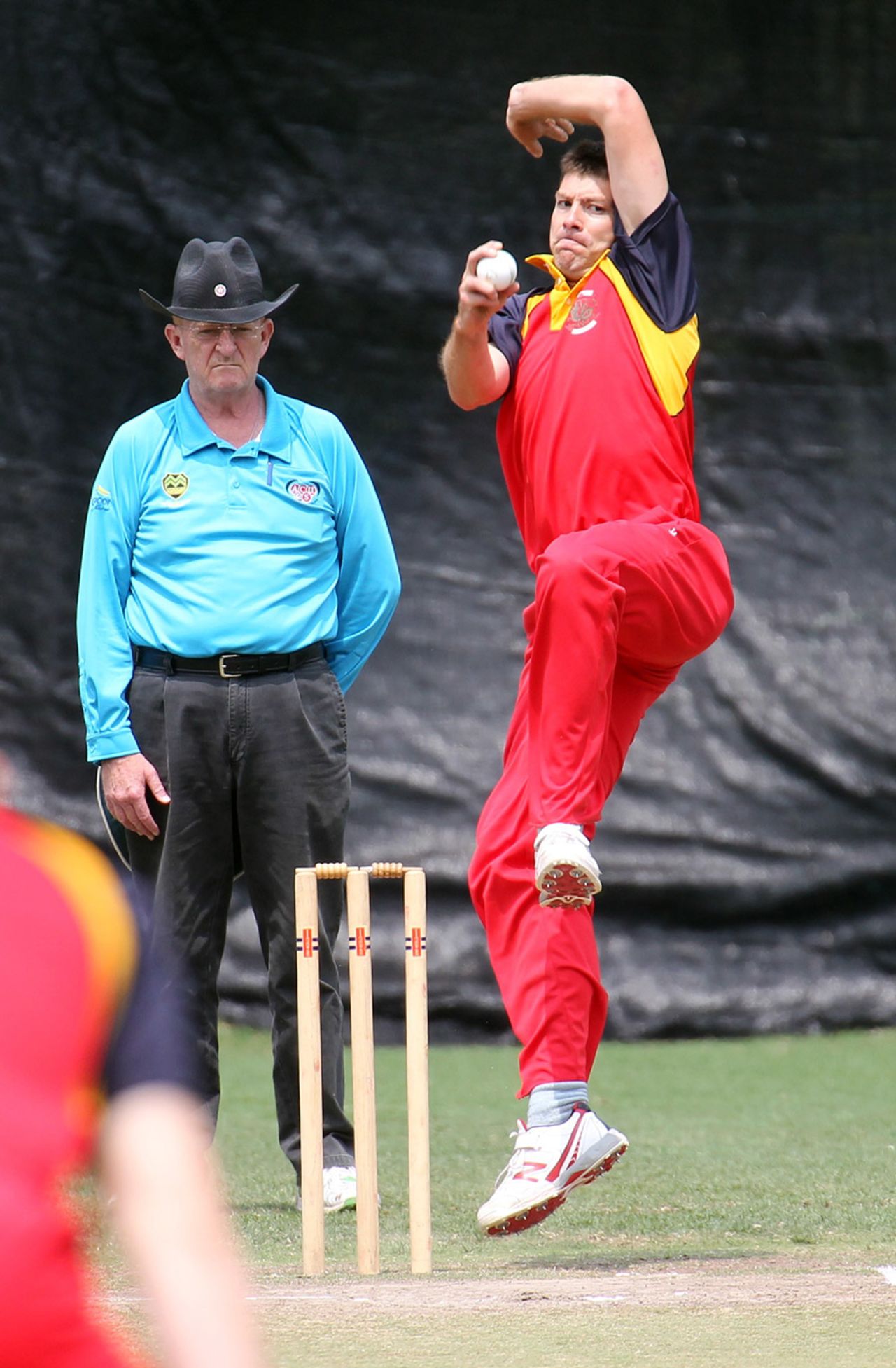Simon Cook runs in to bowl. Umpire is Clive Howard, HKCC v. Ch. Auto Pakistan Association at Hong Kong Cricket Club. 26th April 2015