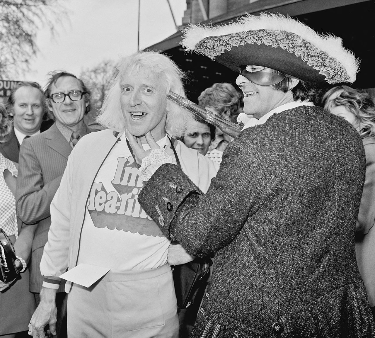 Fred Trueman with Jimmy Savile during a Variety Club of Great Britain charity walk luncheon, England, April 19, 1973