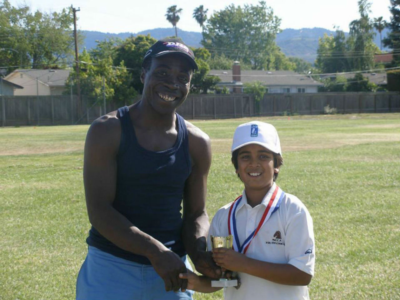 Owen Graham presenting a trophy to NCCA Youth player