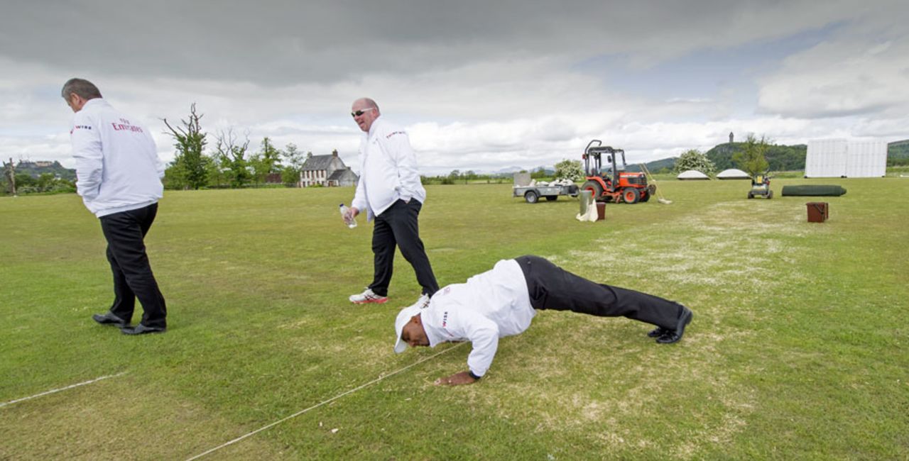 Close inspection: Umpire Gregory Brathwaite uses a novel way to examine ground conditions, Scotland v Afghanistan, ICC Intercontinental Cup, 2nd day, Stirling, June 3, 2015