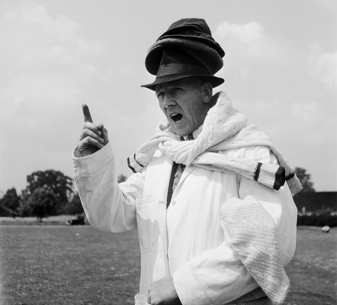 Umpire Arthur Belson wears several hats and sweaters, Amersham Hill, June 9, 1949