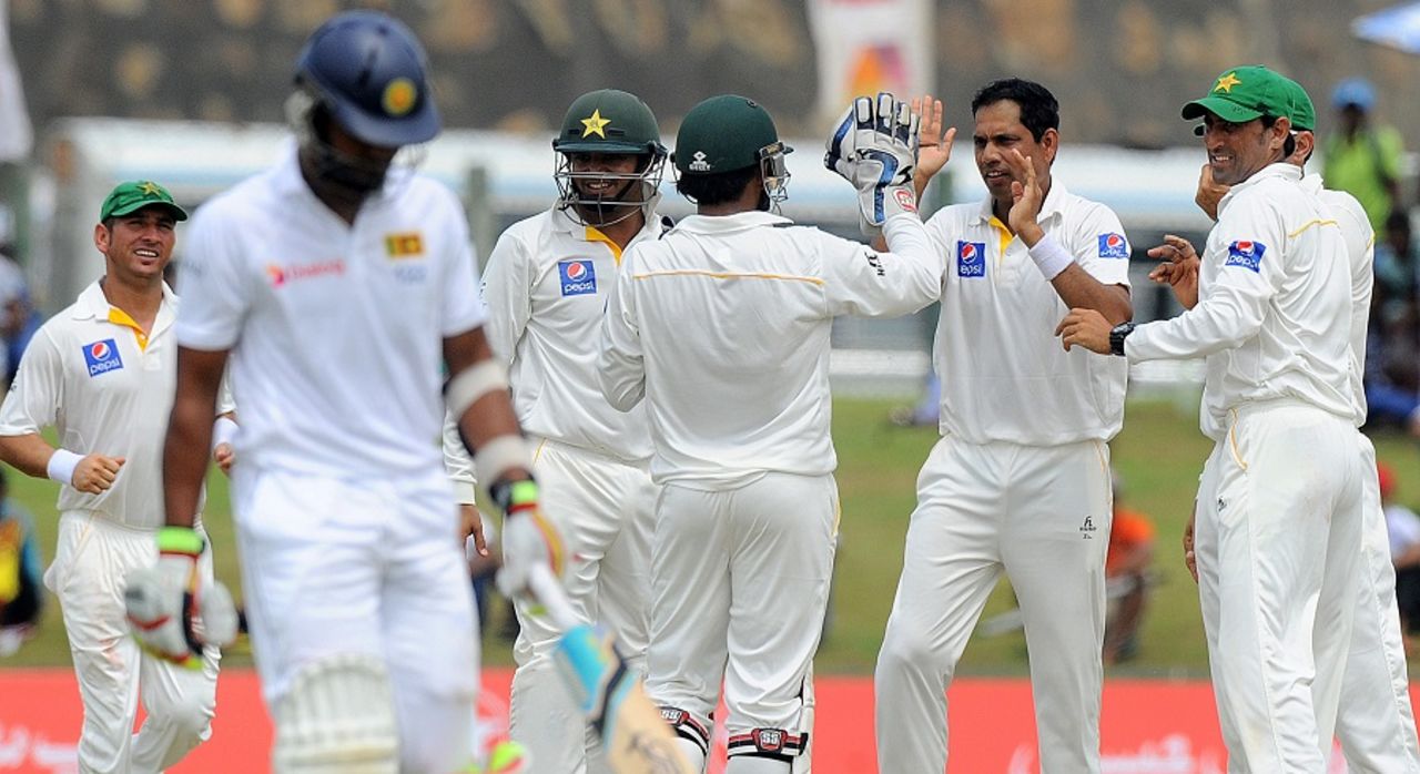 Zulfiqar Babar is greeted by team-mates after he removed Dinesh Chandimal, Sri Lanka v Pakistan, 1st Test, Galle, 3rd day, June 18, 2015