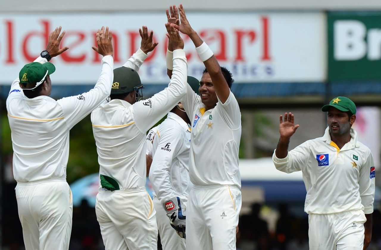 Zulfiqar Babar takes high-fives from his team-mates, Sri Lanka v Pakistan, 2nd Test, Colombo, 2nd day, June 26, 2015