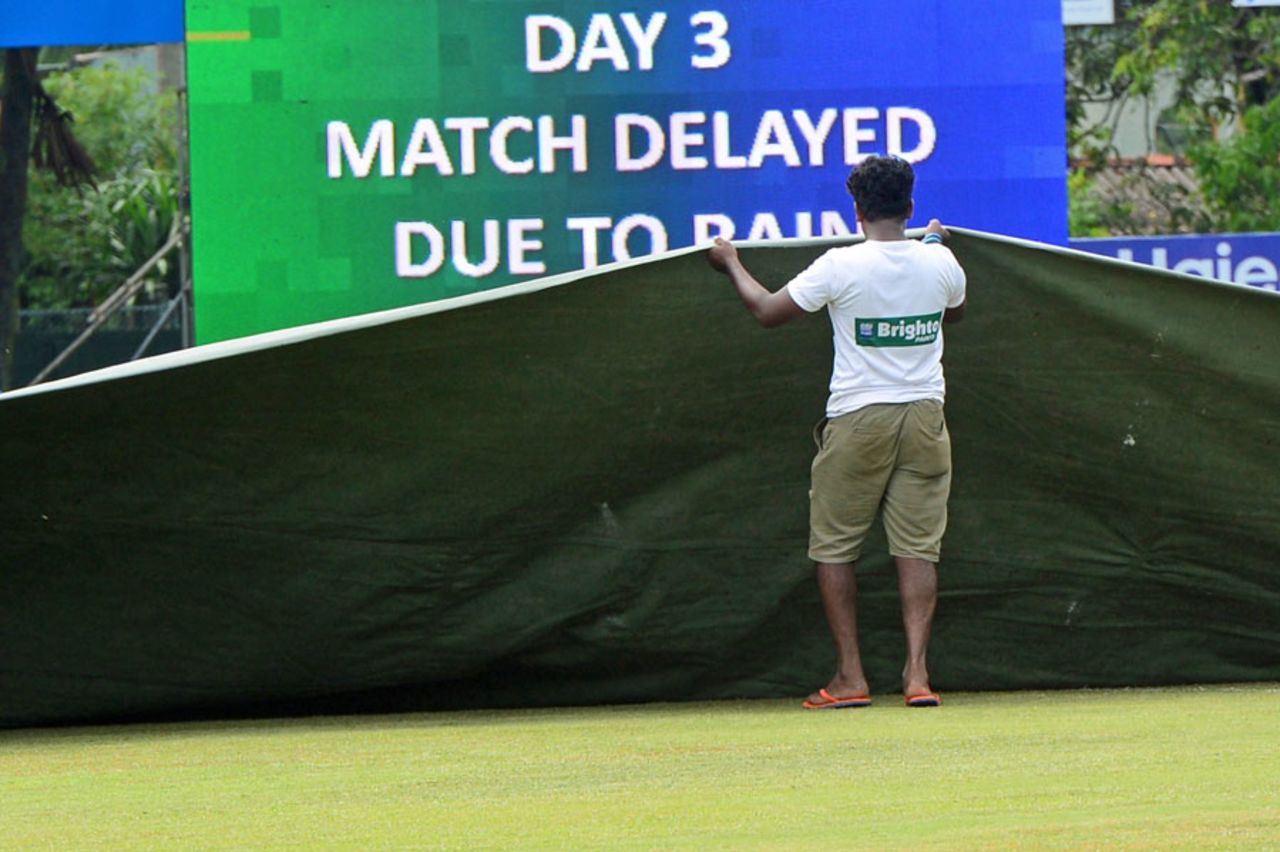 Ground staff cover the field at P Sara Oval after a brief spell of rain in the morning, Sri Lanka v Pakistan, 2nd Test, Colombo, 3rd day, June 27, 2015