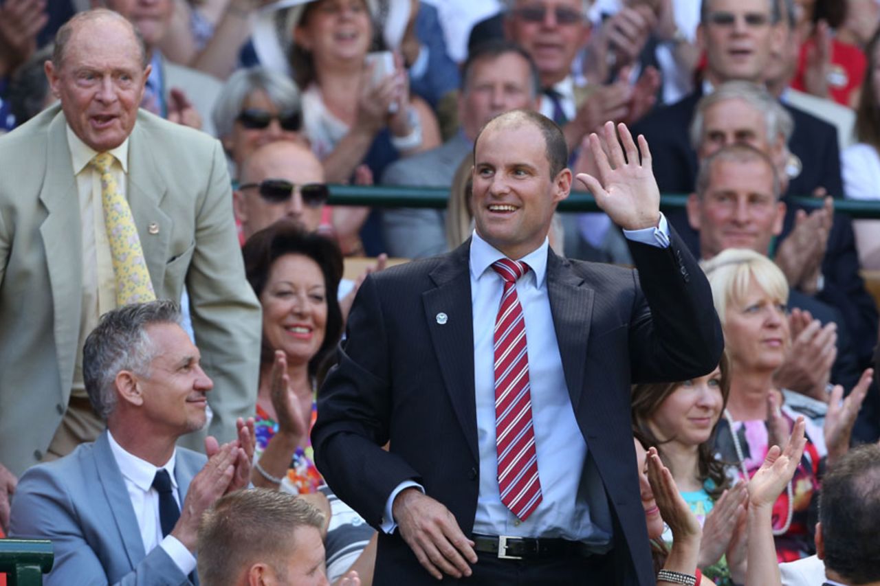 Andrew Strauss waves to the crowd at Wimbledon as Geoffrey Boycott looks on, July 4, 2015