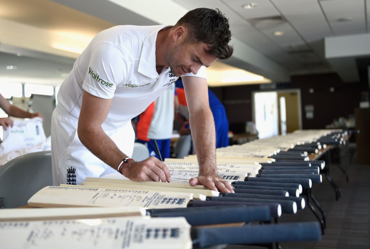 James Anderson signs some commemorative bats, Cardiff, July 5, 2015