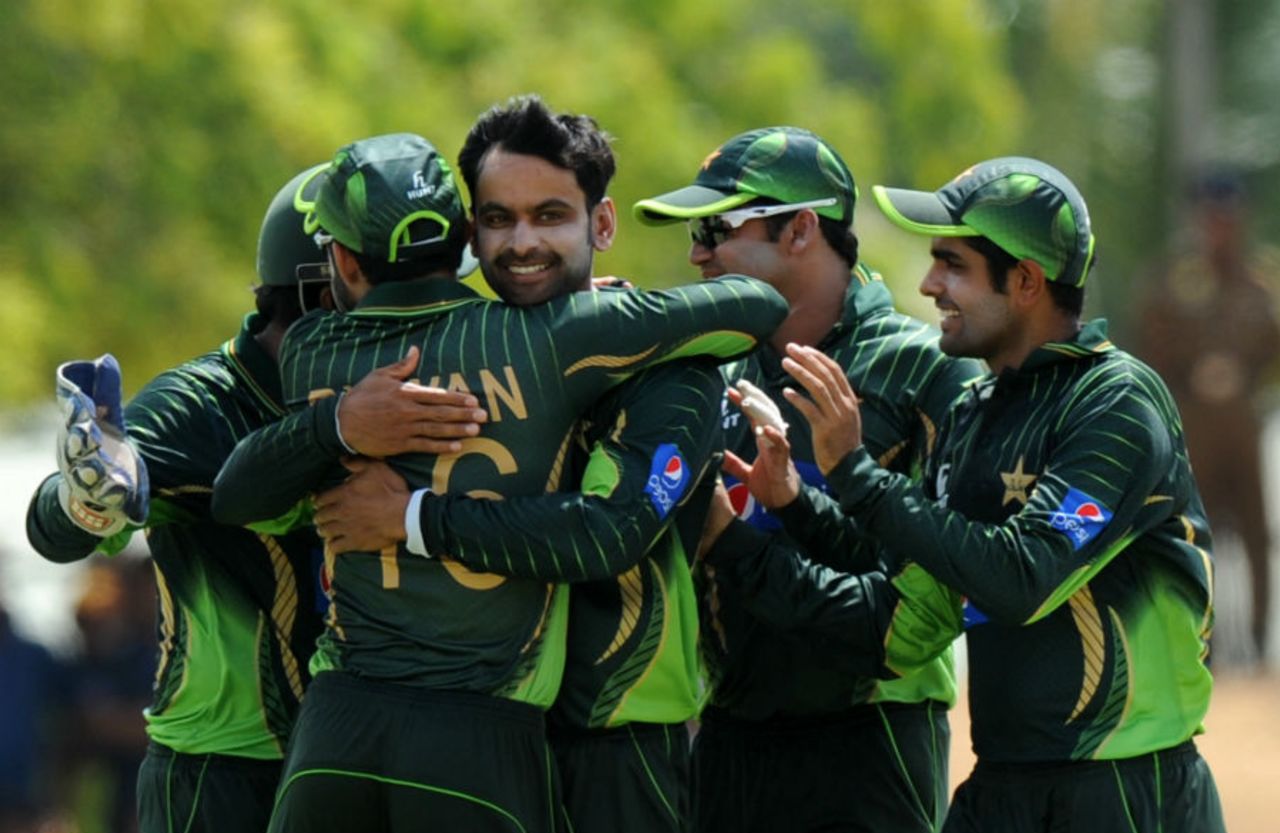 Mohammad Hafeez is mobbed by his team-mates, Sri Lanka v Pakistan, 1st ODI, Dambulla, July 11, 2015