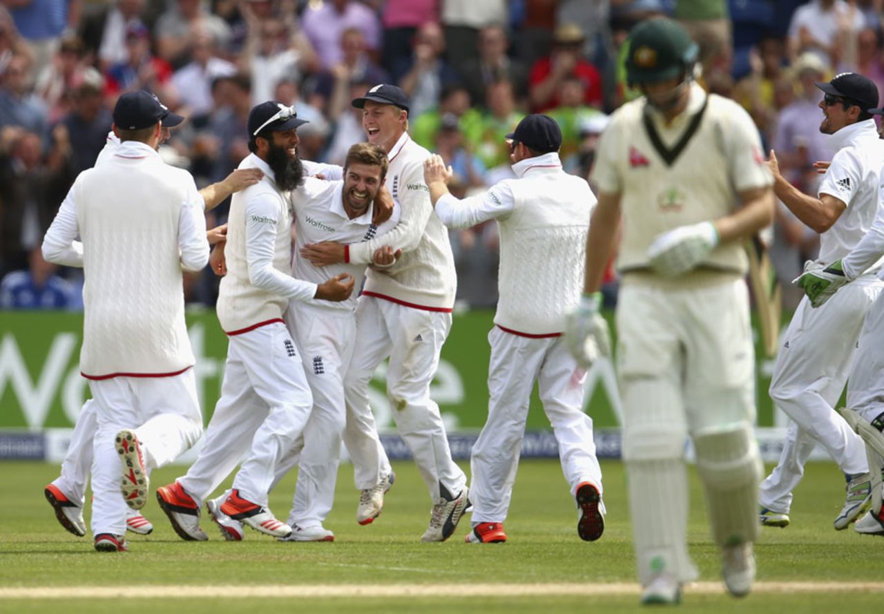 England's fielders swamp Mark Wood after the dismissal of Adam Voges, England v Australia, 1st Investec Ashes Test, Cardiff, 4th day, July 11, 2015