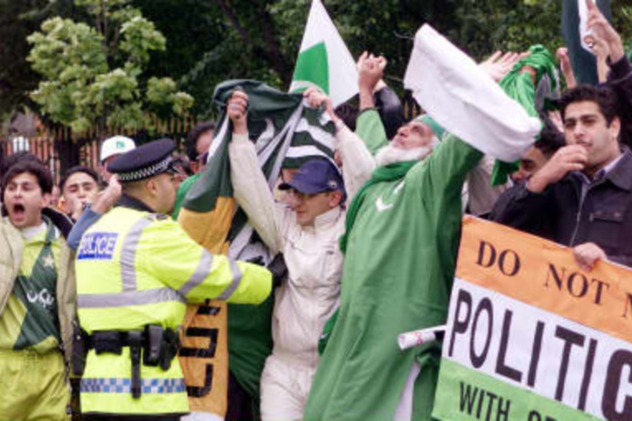 Police hold back enthusiastic Pakistan fans 08 June 1999, who held up traffic before the day's Cricket World Cup match against India at Old Trafford, Manchester. The final will be at Lords in London 20 June 1999