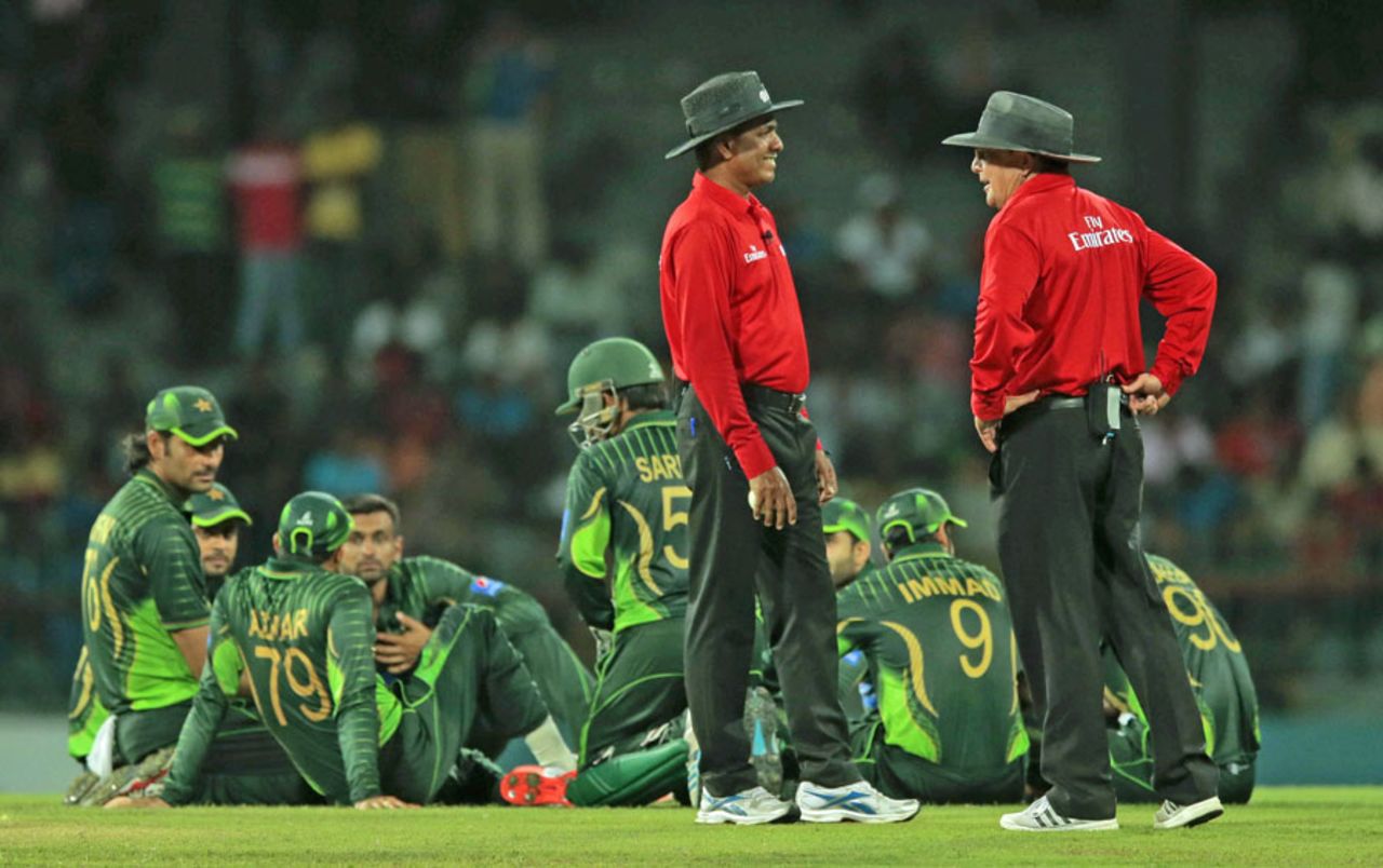 The players and umpires stand in the middle of the playing area after crowd trouble halted play, 3rd ODI, Colombo, July 19, 2015