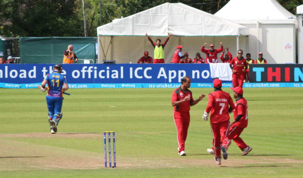 Munis Ansari and the Oman bench celebrate the wicket of Stephan Baard, Namibia v Oman, World T20 Qualifier, Play-off, Dublin, July 23, 2015