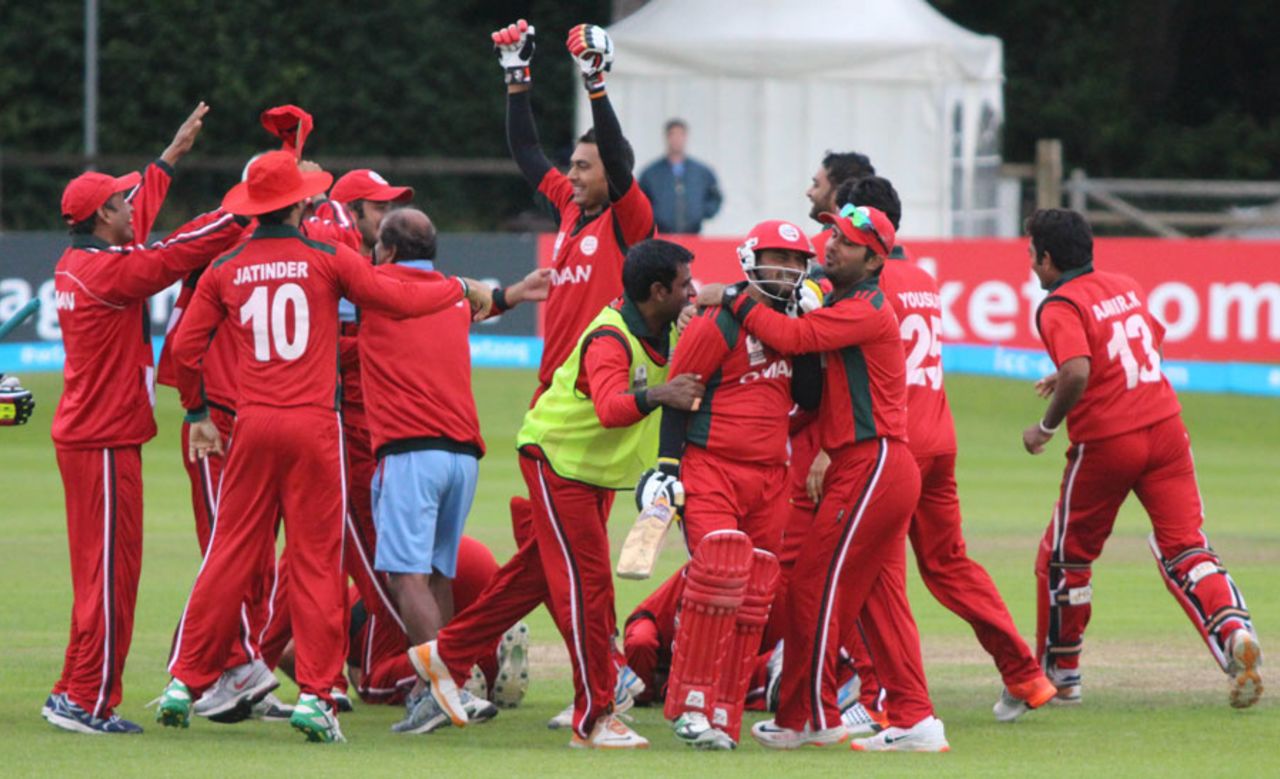 Zeeshan Siddiqui is mobbed by elated team-mates, Namibia v Oman, World T20 Qualifier, 4th qualifying playoff, Dublin, July 23, 2015