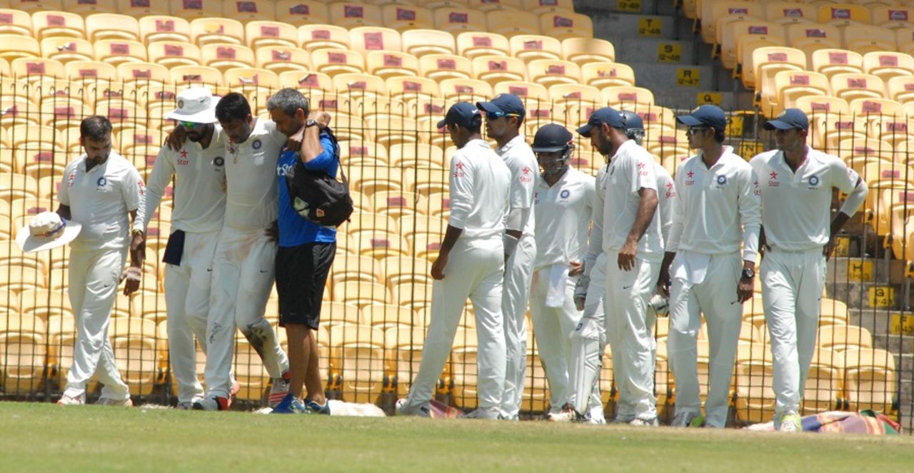 Pragyan Ojha is helped off the field. India A v Australia A, 1st unofficial Test, Chennai, 3rd day, July 24, 2015