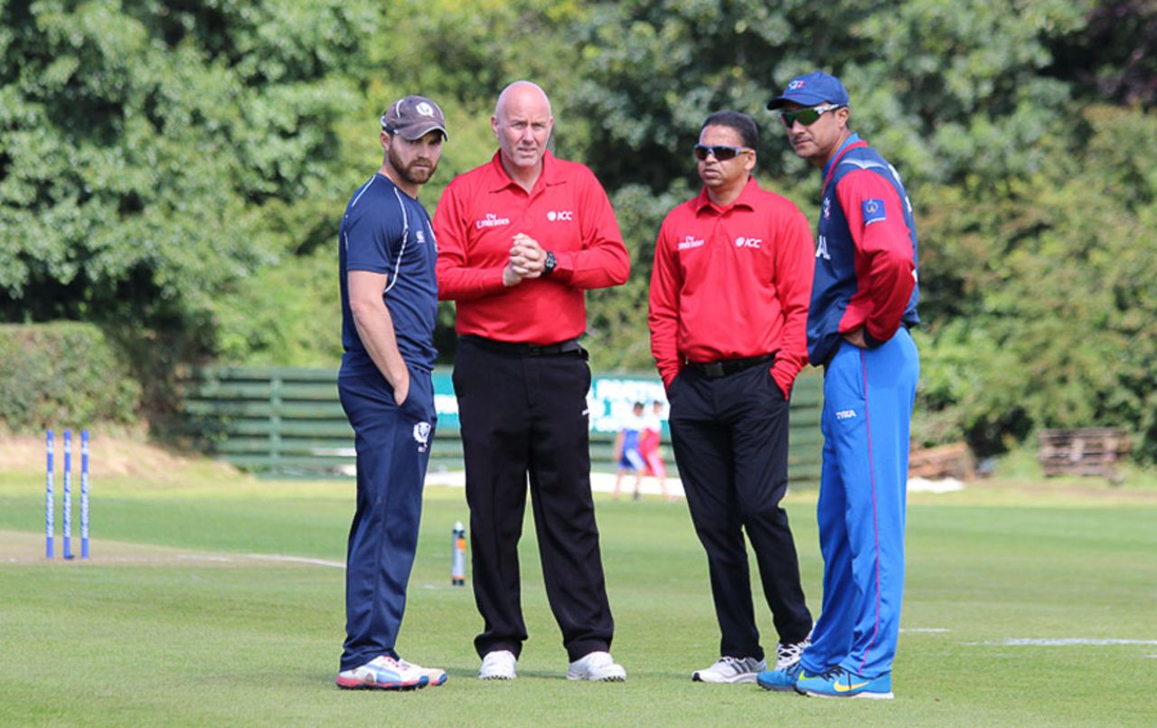 Preston Mommsen and Paras Khadka chat with the umpires regarding the playing conditions, Scotland v Nepal, ICC World Cricket League Championship, Ayr, July 29, 2015