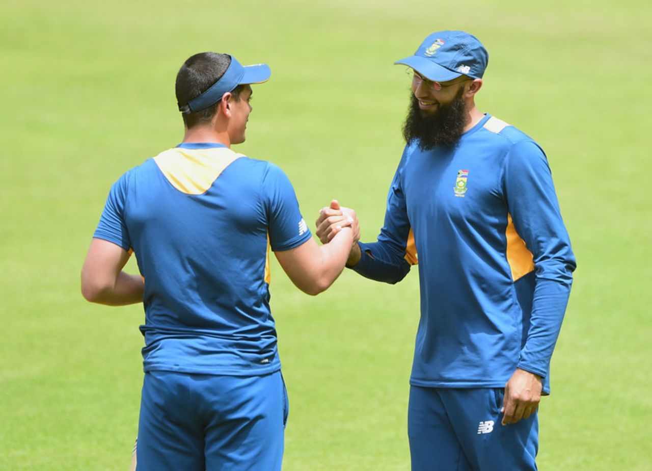 Hashim Amla and Quinton de Kock share a lighter moment during training, Dhaka, July 29, 2015
