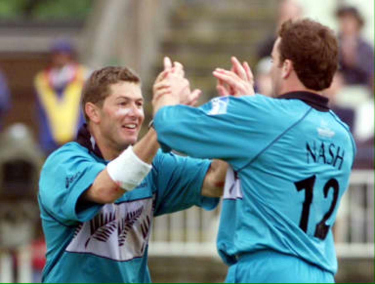New Zealand bowler Geoff Allott (L) celebrates with Dion Nash who ran out South Africa's captain Hansie Cronje 10 June 1999. Allott had earlier broken the world record for wickets taken in a World Cup series with 19 during their Super Six match in the Cricket World Cup at Edgbaston