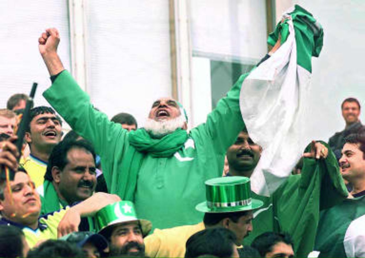 Pakistani fans in a carnival cheer at the Oval cricket ground in London during the World Cup match against Zimbabwe at the Oval in London, 11 June 1999.