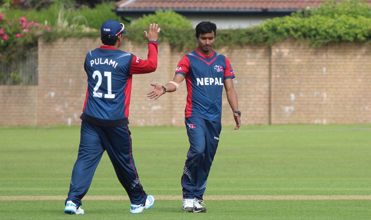 Sompal Kami gets congratulated after taking the wicket of Preston Mommsen, Scotland v Nepal, ICC World Cricket League Championship, Ayr, July 29, 2015