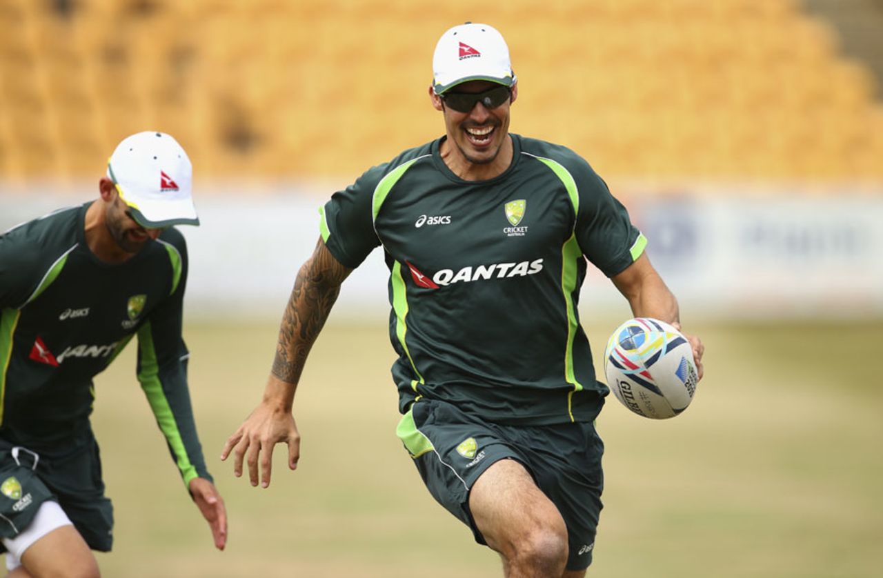Mitchell Johnson evades Nathan Lyon during a game of touch rugby, Northampton, August 12, 2015
