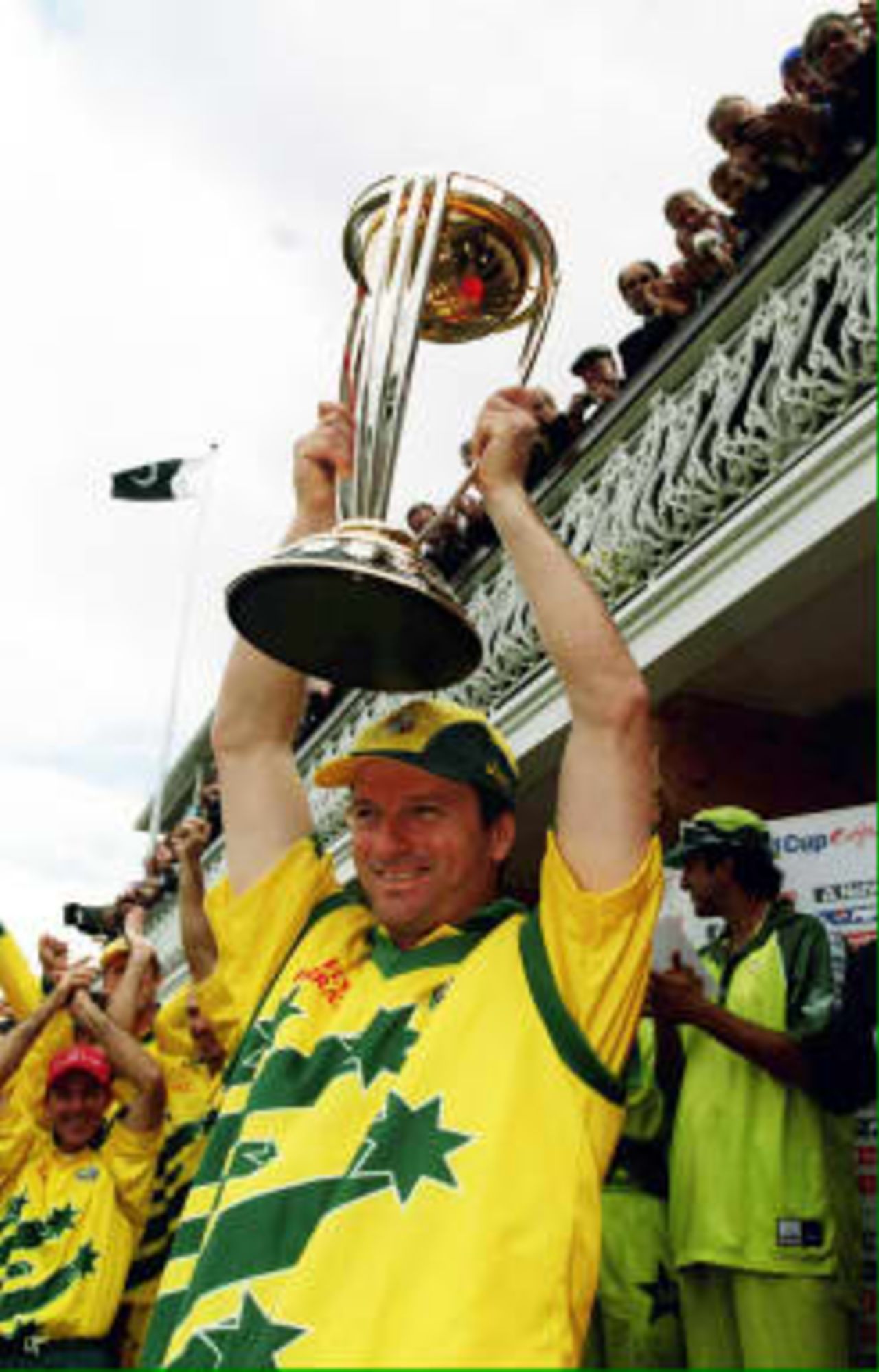 Victorious Australian cricket captain Steve Waugh lifts the Cricket World Cup trophy after Australia defeated Pakistan by eight wickets in the final at Lords, 20 June 1999.