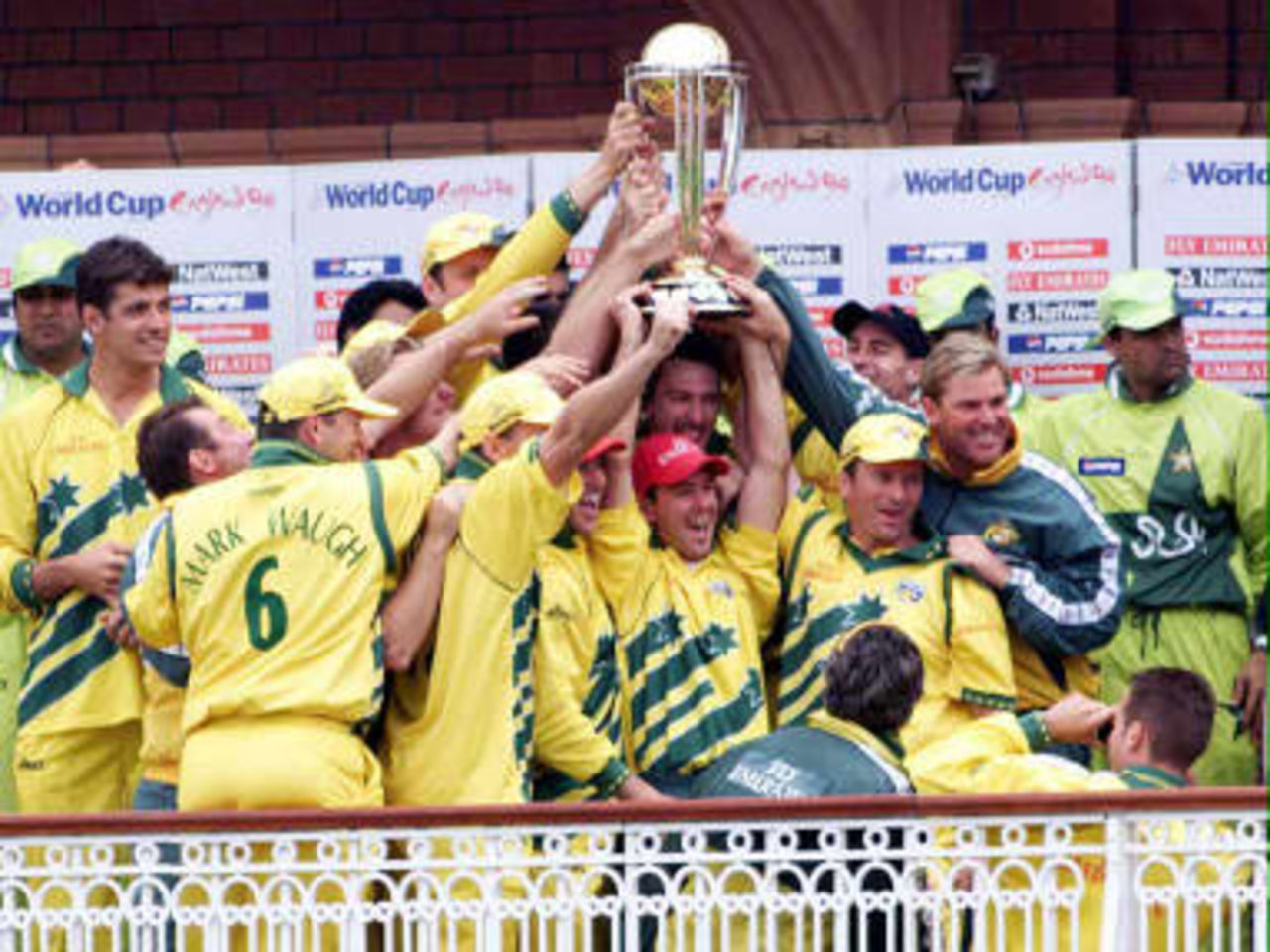 The victorious Australian cricket team lift the World Cup trophy after beating Pakistan by eight wickets in the finals at Lords in London, 20 June 1999.