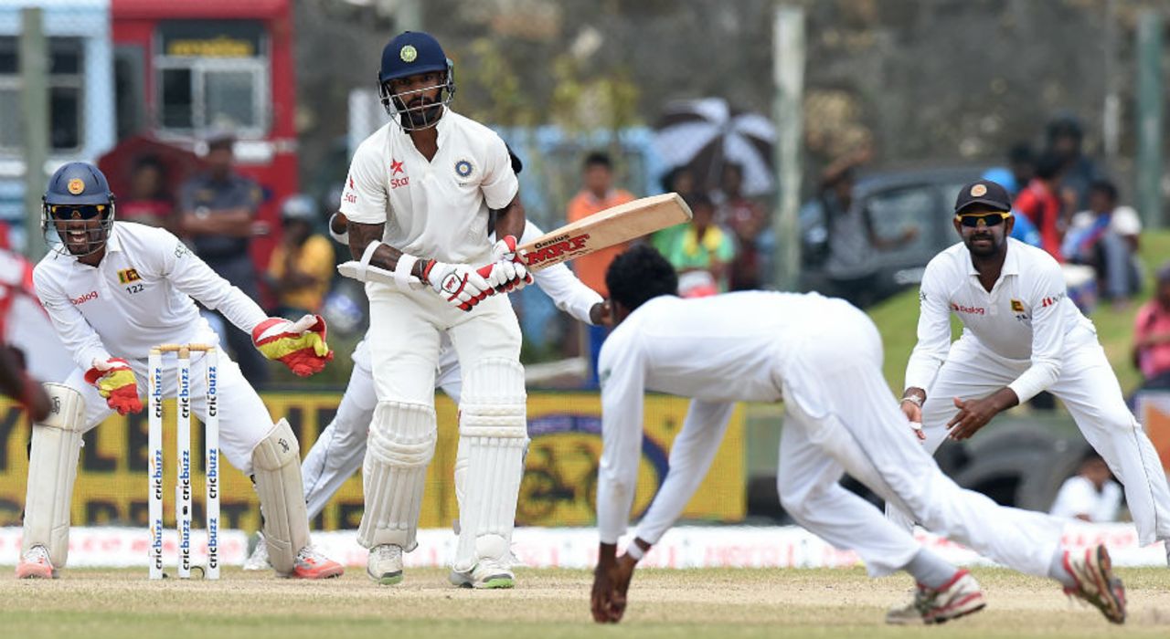 Shikhar Dhawan watches as Tharindu Kaushal takes a diving return catch to dismiss him, Sri Lanka v India, 1st Test, Galle, 4th day, August 15, 2015