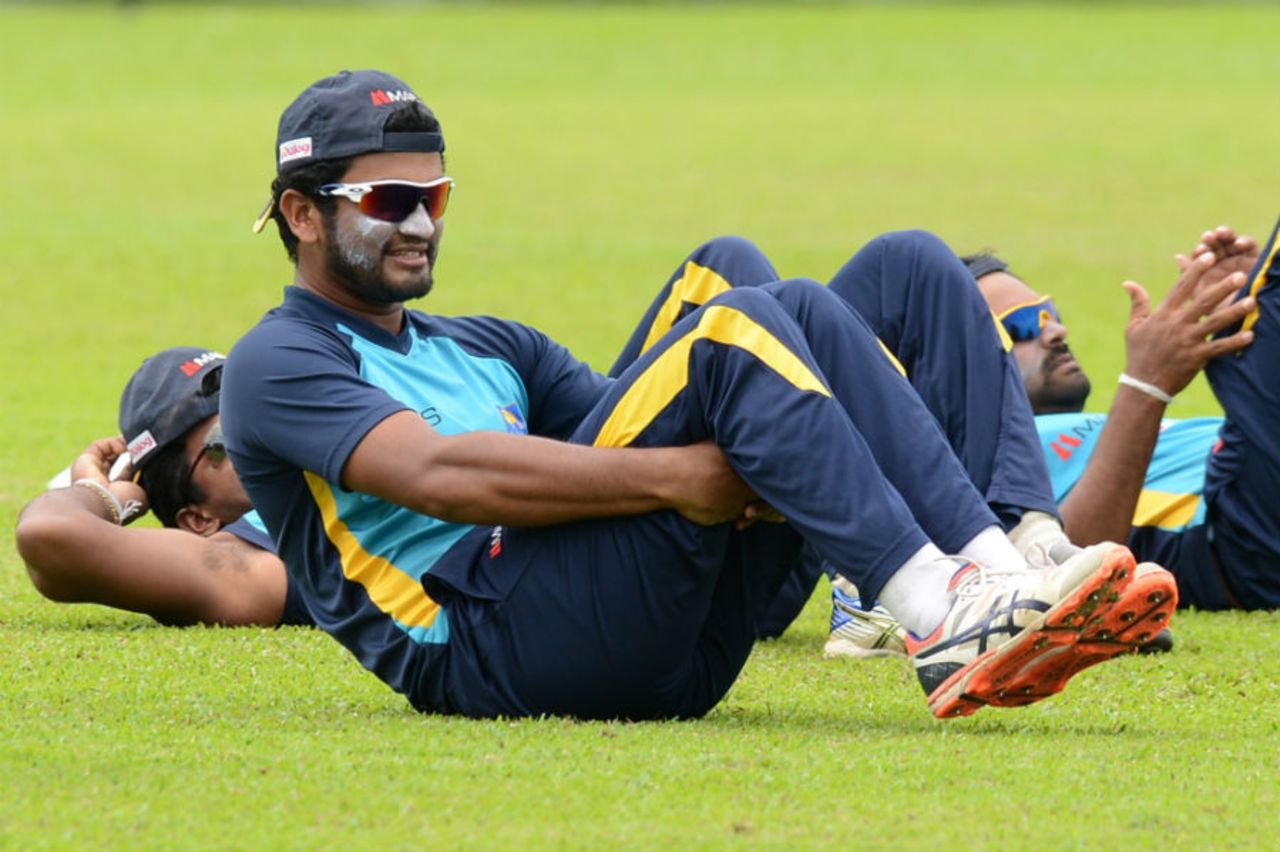 Dimuth Karunaratne stretches during a training session, Colombo, August 18, 2015 